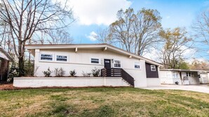 A single-story house with a front porch, a staircase leading to the entrance, and a small front yard. - Modern Beauty in Crestline Park (Birmingham)