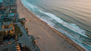 A coastal cityscape with a beach and ocean. - Massive 5BR Resort Style Retreat with Heated Pool (San Diego)
