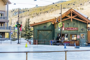 A rustic wooden building with a sign reading "Dercum Square Ice Rink". - Buffalo Lodge #8361 (Keystone)