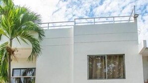 A modern two-story building with a flat roof, large windows, and a concrete entrance area. - Dilla House  (Cartagena)