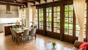Un amplio espacio de sala con un sofá, una mesa de comedor y una cocina al fondo.