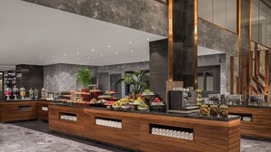 A modern hotel lobby with a marble floor, wooden reception desk, and a large mirror. - Four Points® by Sheraton Accra Airport Hotel (Accra)