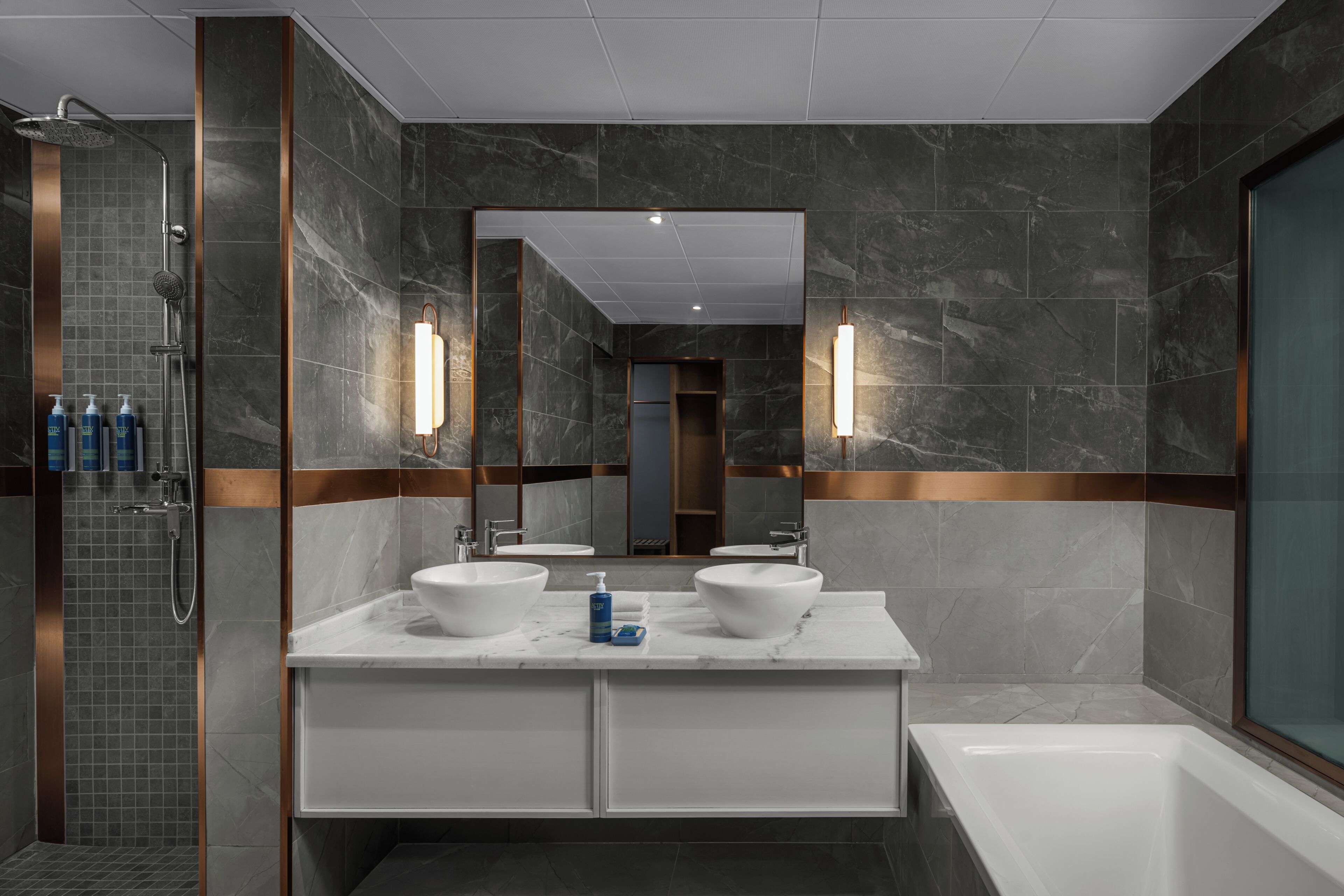 A modern bathroom with two sinks, a shower, and a bathtub.