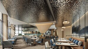 A modern restaurant with a unique ceiling design, wooden flooring, and a mix of seating options including tables and booths.