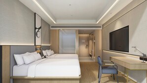 A modern hotel room with a large bed, a desk, and a TV.