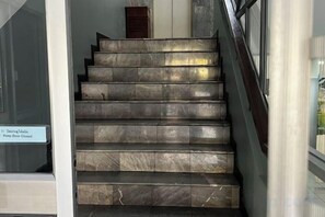 A set of marble stairs leading to an interior space.