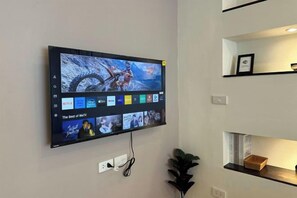 A wall-mounted TV displaying a movie with a selection of other films and a 'Best of WTV' section.