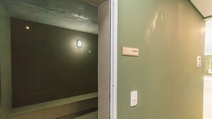 A hallway with a sign indicating a sauna room.