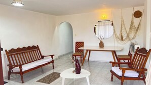 A living room with a sofa set, a coffee table, and a dining table with chairs. - Balconee Big Apartment Centre (Santa Marta)