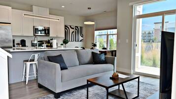 Premier Apartment, Patio, Lake View | Living area | 55-inch TV with digital channels, streaming services