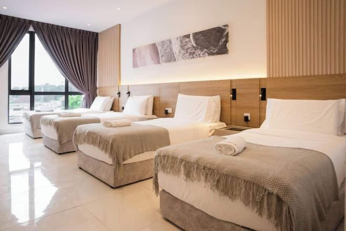 A hotel room with three beds, a large window, and a city view.