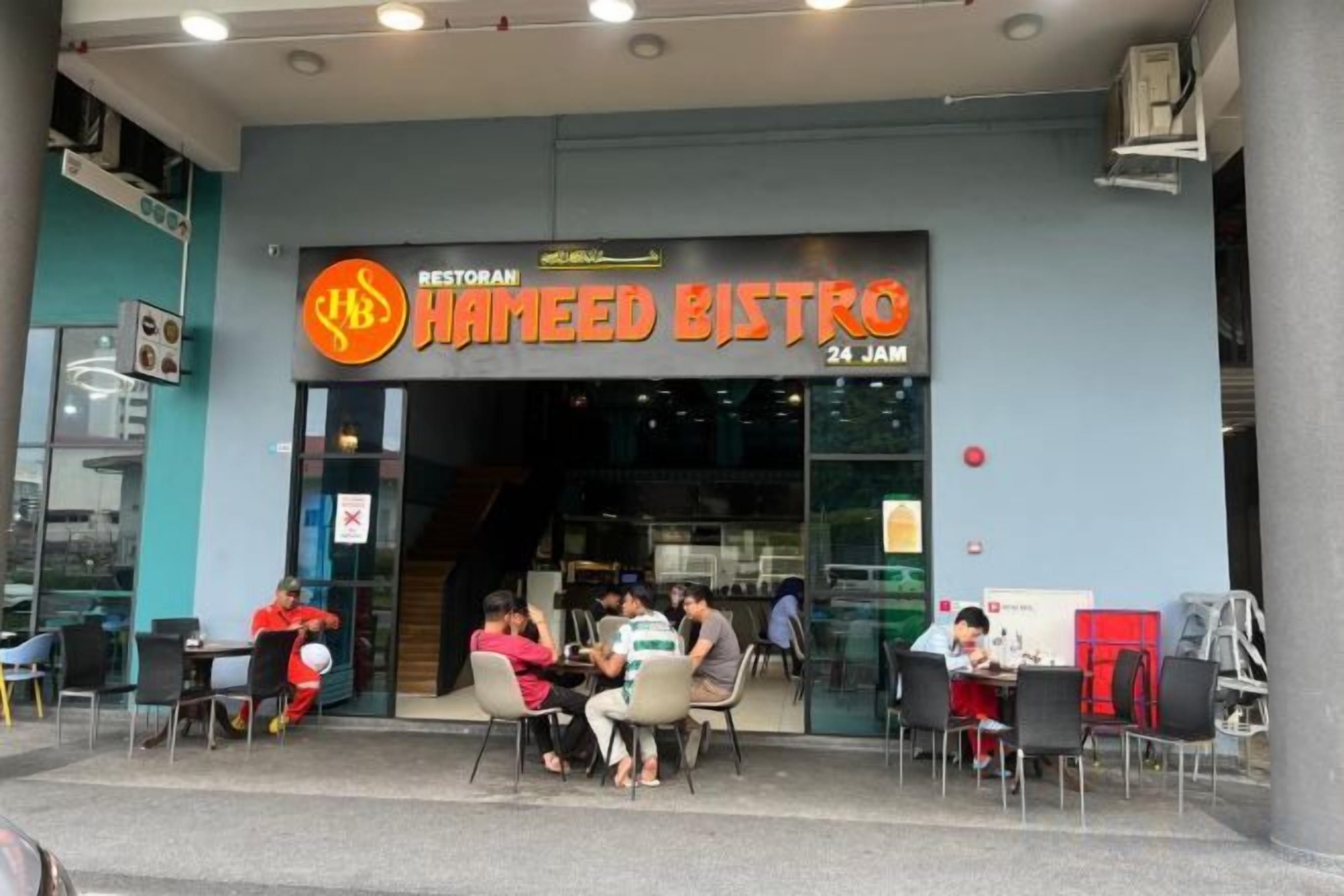A restaurant named Hameed Bistro with outdoor seating and a visible staircase leading to the entrance.