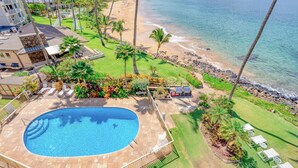 A resort with a swimming pool, beach, and ocean view.