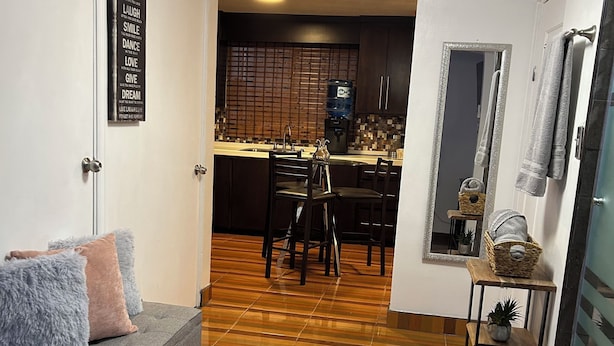 A modern living room with a grey sofa, wooden flooring, and a fluffy rug. - Your private space in an excellent location (Juárez)
