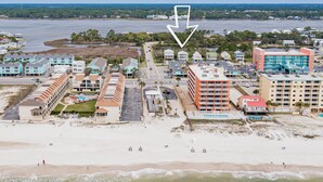 A coastal hotel with multiple buildings, a beach, and a body of water. - Beach Days & Fire Nights! Family 3BR Duplex Just Steps from the Sand! (Gulf Shores)