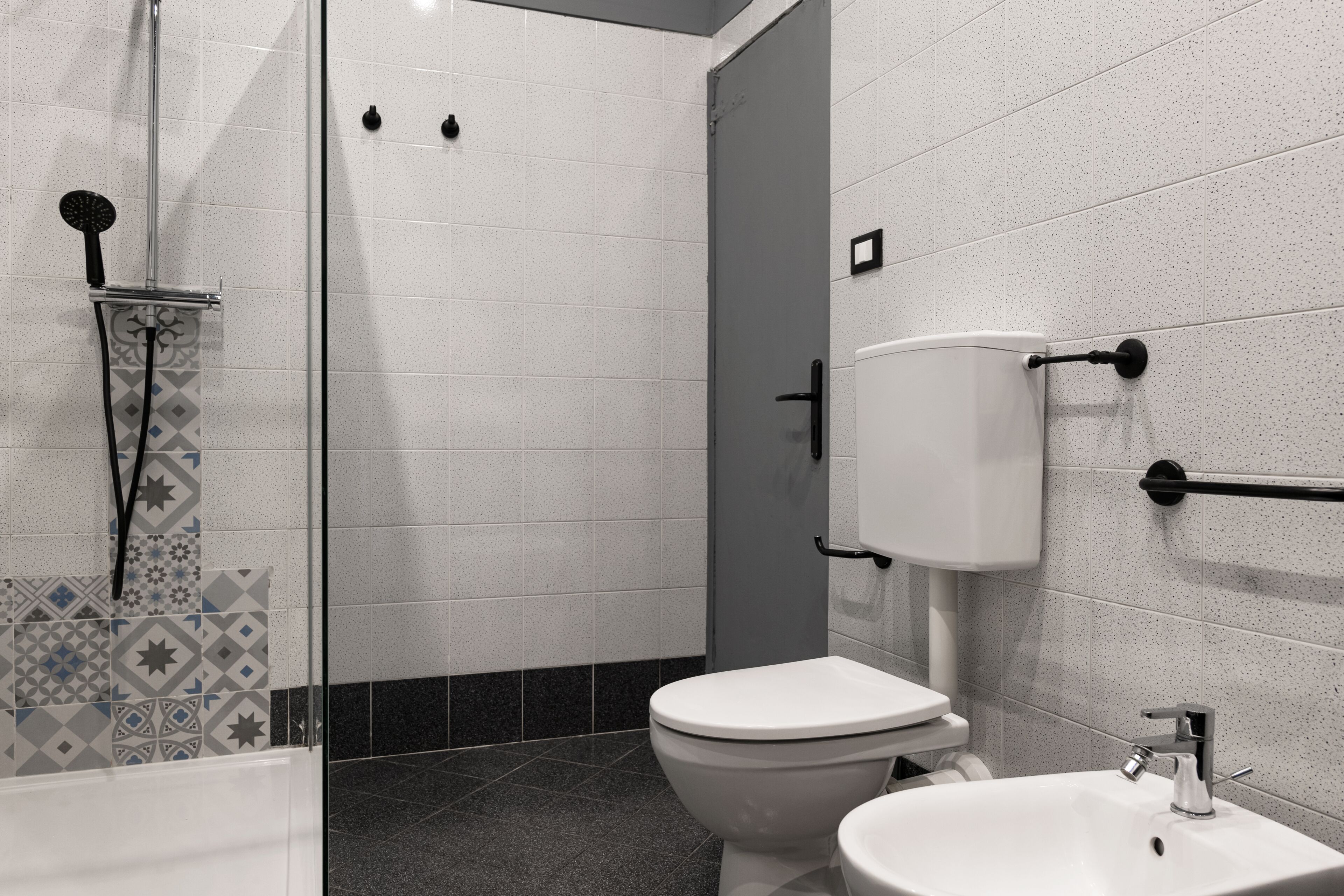 A bathroom with a toilet, sink, and shower.