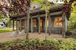 A wooden house with a porch, a brick pathway, and a garden. - Abode at West Ketchum Farmhouse, downtown access (Ketchum)