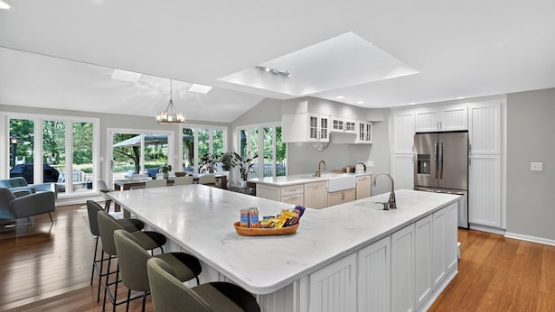 A spacious kitchen with a large island, white cabinetry, and a stainless steel refrigerator. - Secluded Luxe 5BR Estate Pool, Wineries, Near ND (Niles)