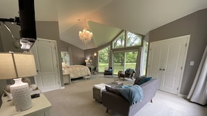 A spacious living area with a large window, a chandelier, and a cozy seating arrangement. - Secluded Luxe 5BR Estate Pool, Wineries, Near ND (Niles)