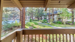 Une terrasse en bois offrant une vue sur un quartier résidentiel, avec des maisons et une route.