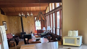 A kitchen with wooden cabinets, a microwave, and a stove. - Rustic Cabin Getaway Near Kenora (Kenora)