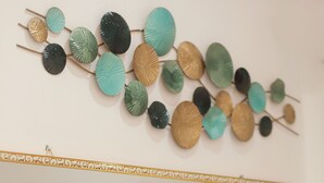 Un muro con un decoro di ornamenti circolari e uno specchio incorniciato.