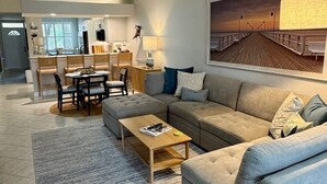 A modern living room with a sofa, coffee table, and dining area. - Charming Three Bedroom Villa in Beautiful Naples (Naples)