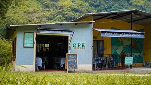 A café with outdoor seating and a menu board. - CPHHOSTAL (Villa Restrepo)