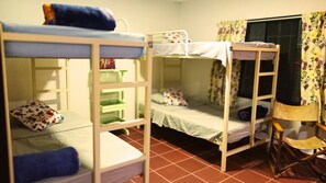 A bunk bed room with a window, a chair, and a small table. - CPHHOSTAL (Villa Restrepo)