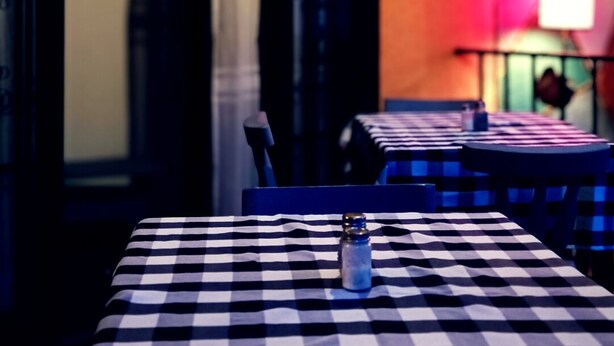 A restaurant interior with a checkered tablecloth, a salt shaker, and a sign with 'CPH' on the wall. - CPHHOSTAL (Villa Restrepo)