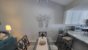 A dining area with a table, chairs, and a chandelier. - Quiet, Turn-Key, Newly Furnished, Beautiful! CLOSE to EVERYTHING! (Fort Myers)