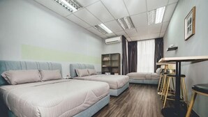 A hotel room with two beds, a sofa, a dining table, bar stools, and an air conditioning unit. - Tun Aminah Shoplot 10-14pax KTV Mahjong Funhouse (Sekudai)