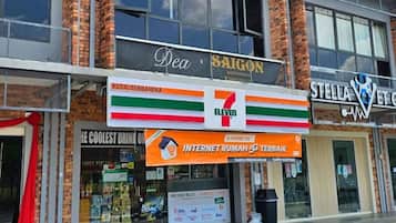A building with a 7-Eleven store, a Kedi Serbanka, and a Stella Artois sign.