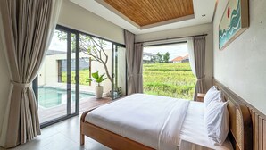 A bedroom with a large bed, a view of a rice field, and a wooden ceiling. - Athaya Canggu Villas by Nagisa Bali (Canggu)