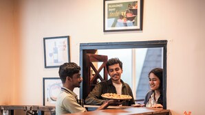 A restaurant counter with a pizza being served. - Zostel Kodaikanal (Vilpatti) (Kodaikanal)