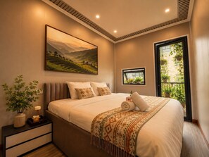 A bedroom with a large bed, a nightstand, a bedside table, a window with a view of greenery, and a painting on the wall. - Hanoi Quarter Life Hostel (Hanoi)