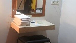A small bathroom with a mirror, a towel rack, a sink, and a stool. - Halina Drive Inn Hotel - Pasay (Pasay)