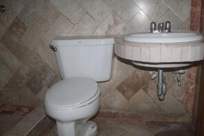 A bathroom with a toilet and a sink.