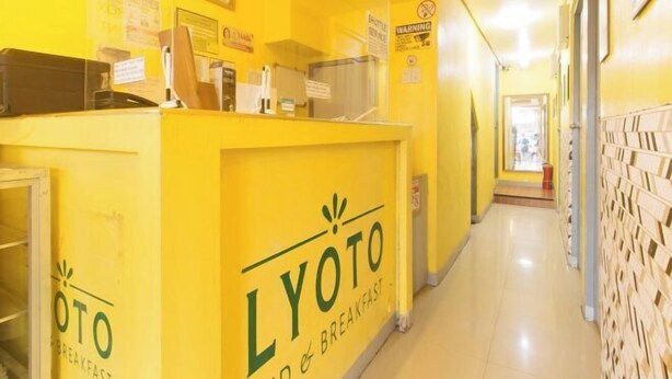A bright yellow interior of a breakfast restaurant with a counter and menu boards.