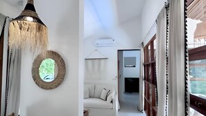 A modern interior with a dining area, a sofa, and a TV in the background. - Villa Bohème, Villa 28 (Koh Samui)