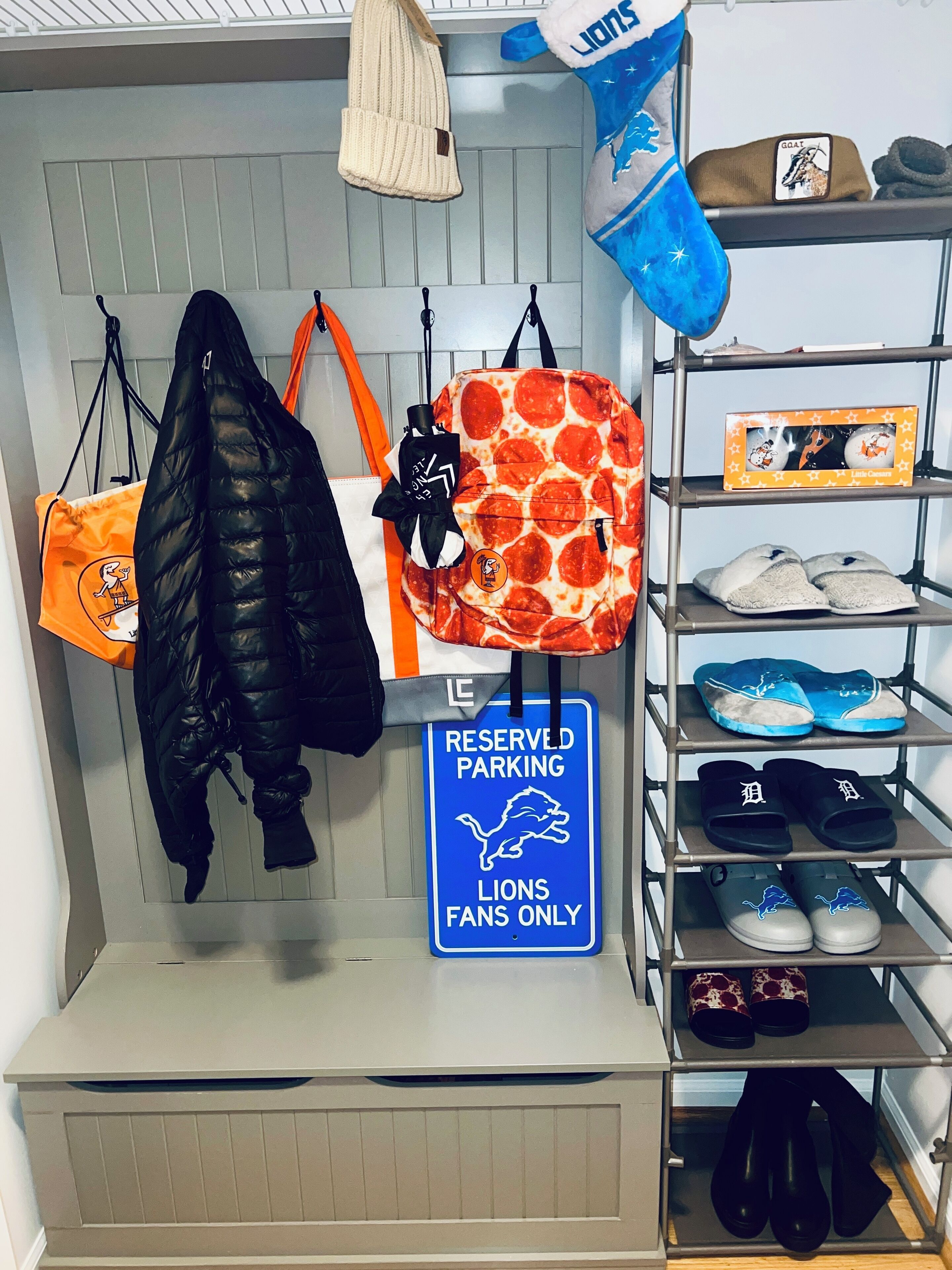 A storage area with various bags, a reserved parking sign, and shelves with shoes and slippers.
