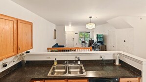 A modern kitchen with wooden cabinets, a double sink, and a dishwasher.