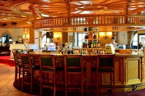 A bar area with wooden furniture, a bartender, and various bottles. - Muju Deogyusan Resort (Muju)
