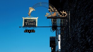 A hotel sign with the name "Hotel Tirol" and decorative elements including a golden lion and a curved structure. - Muju Deogyusan Resort (Muju)