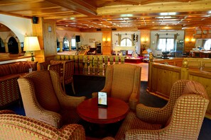 A hotel lobby with a checkered seating area, a piano, and a bar. - Muju Deogyusan Resort (Muju)