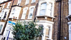 A two-story brick building with white-framed windows and a balcony. A 'Let' sign is visible on the left side. - Rooftop/worktable/Netflix/Parking/Promo/longstay (London)