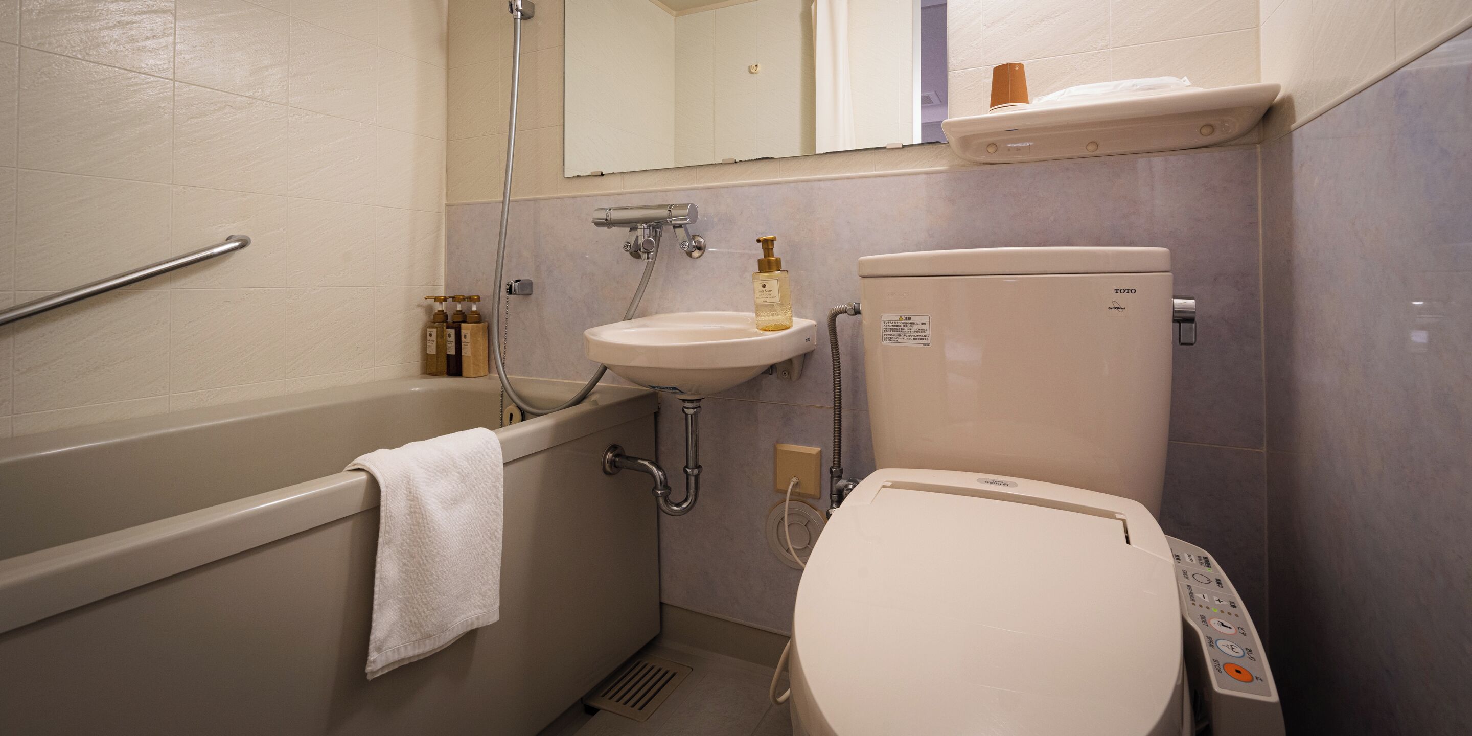 A bathroom with a bathtub, a sink, and a toilet.