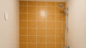 A bathroom with a shower, toilet, and sink. - King Hotel (Huddinge)