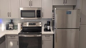 A modern kitchen with stainless steel appliances, including a microwave, oven, and refrigerator. - Modern Downtown Condo- 10 minutes walk to Downtown Phoenix (Phoenix)