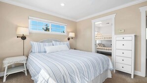 A bedroom with a bed, bedside lamps, a window, and a dresser. - Twin Lakes Surf Cabin - Sleeps Up To 12 (Santa Cruz)